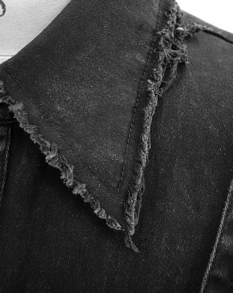Close-up of a punk-style black denim vest collar with frayed edges and stylish distressed details.