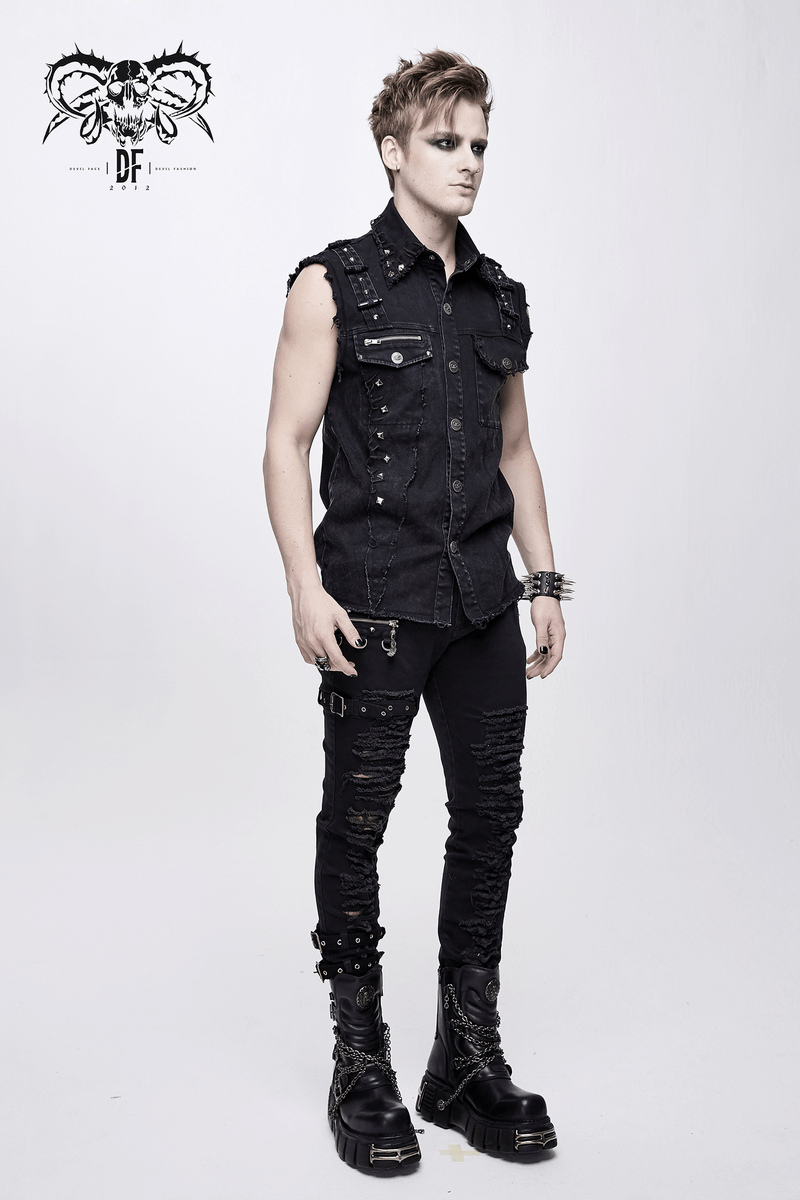 Stylish man in a punk black denim sleeveless vest with silver accents, showcasing alternative fashion.