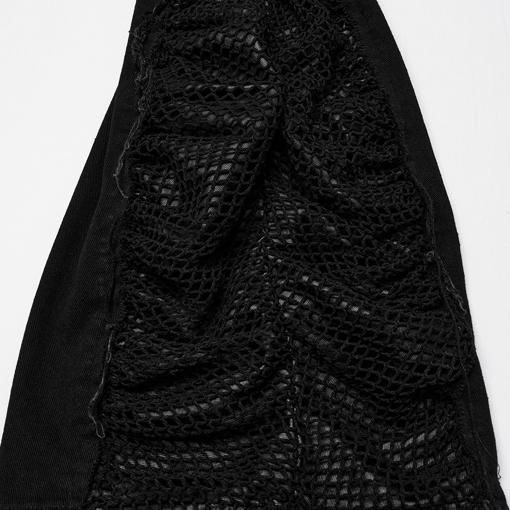 Close-up of black punk pants featuring textured mesh fabric and frayed edges, adding a bold, edgy style.