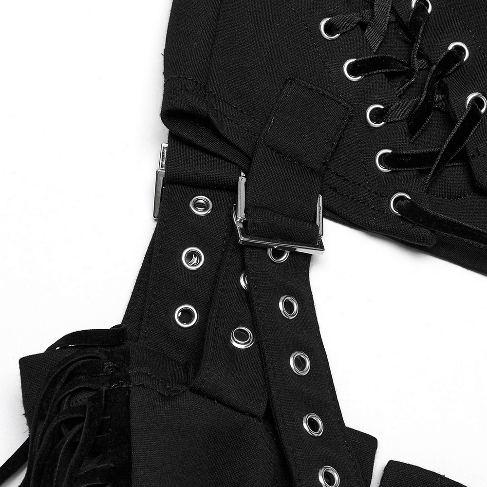 Close-up of black punk detachable tassel pants with lace-up details and silver hardware accents.