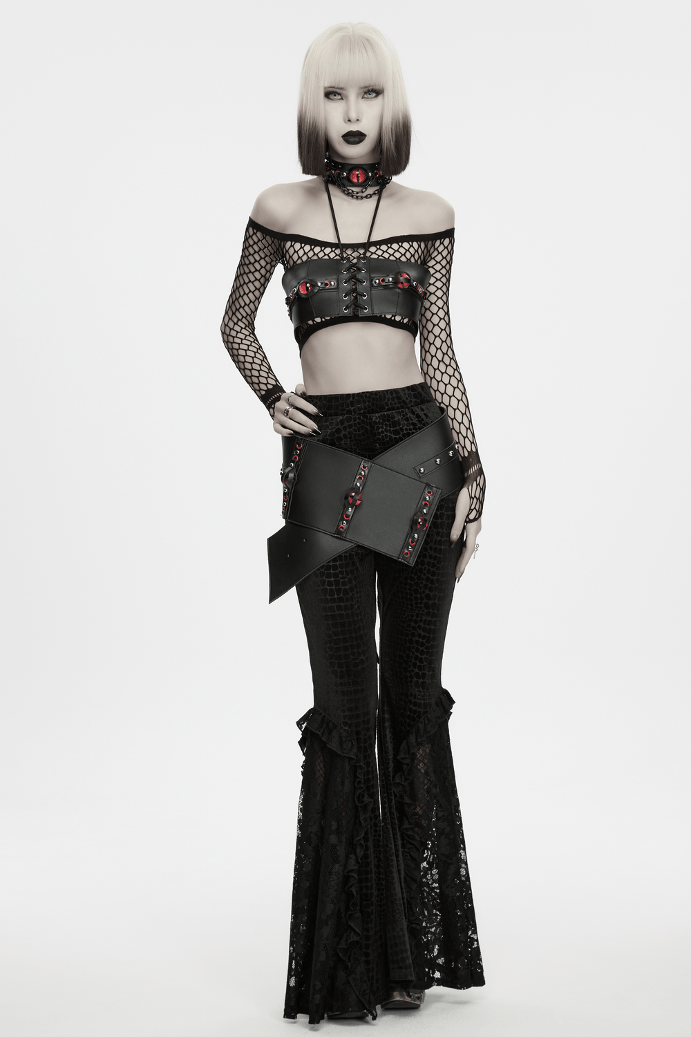 Punk Devil Eye Lace Up Faux Leather Bra Crop Top styled with fishnet and flared pants for a bold gothic look.