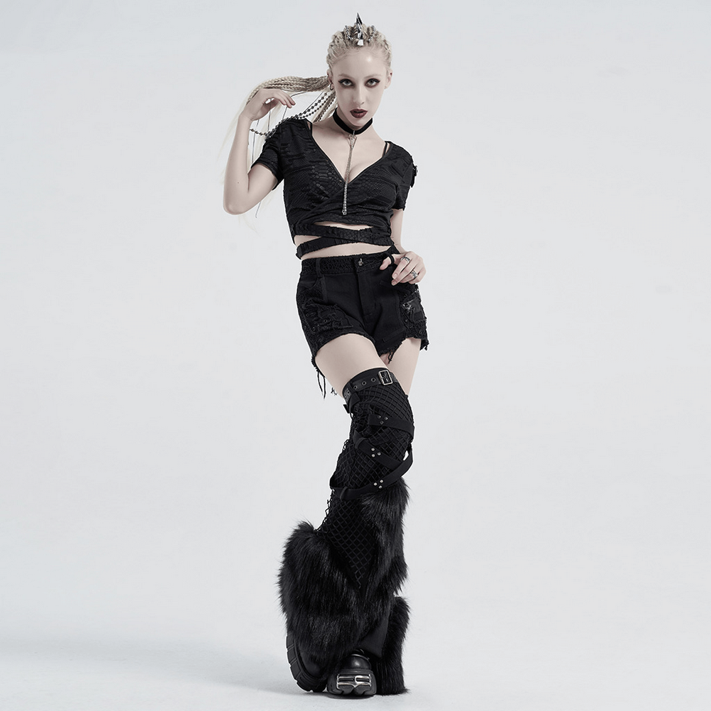 Model showcasing punk gothic outfit with black crop top, ripped details, and edgy knee-high boots.