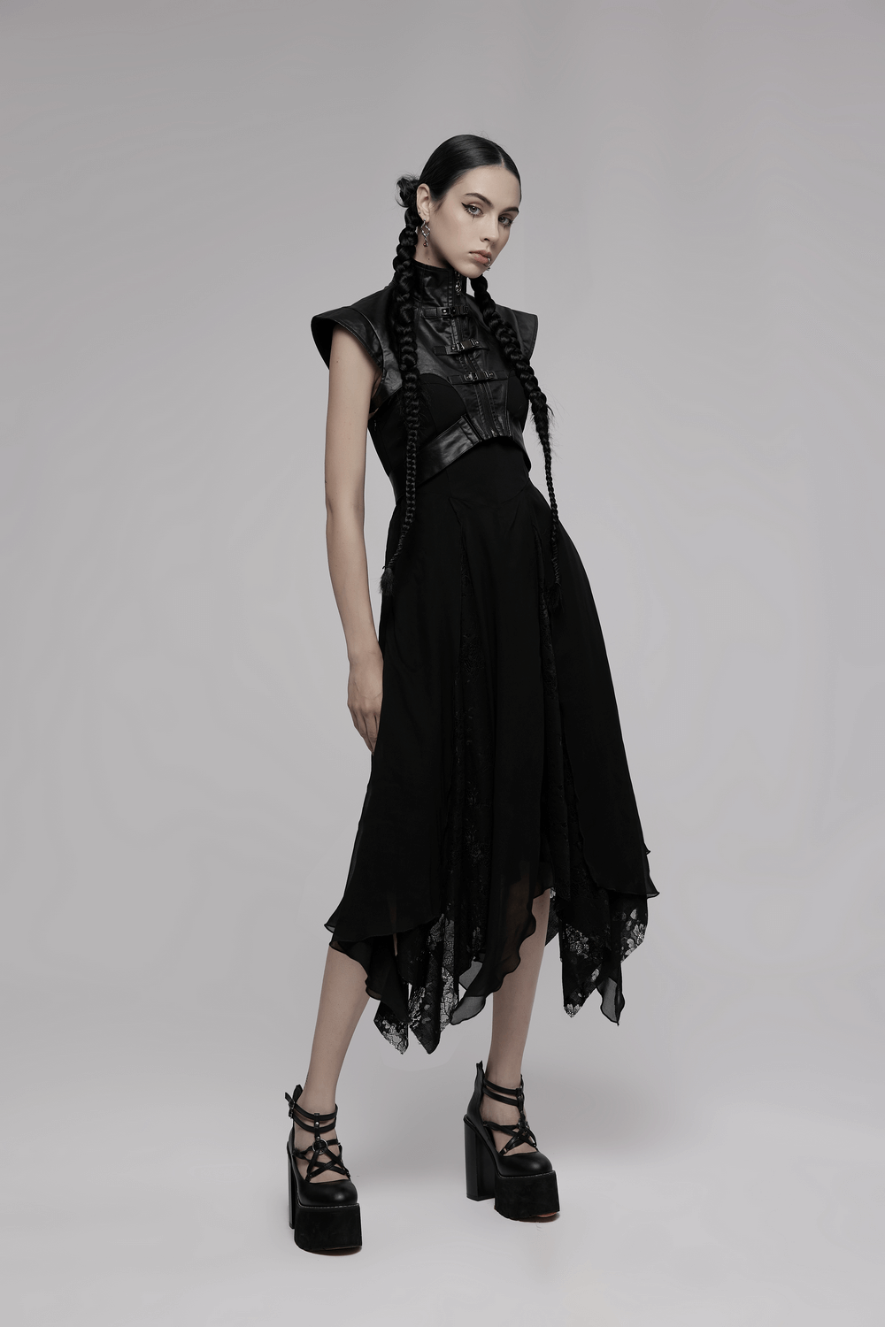 Punk edgy wide shoulder black PU leather vest with lace skirt and platform boots, perfect for a rebellious look.