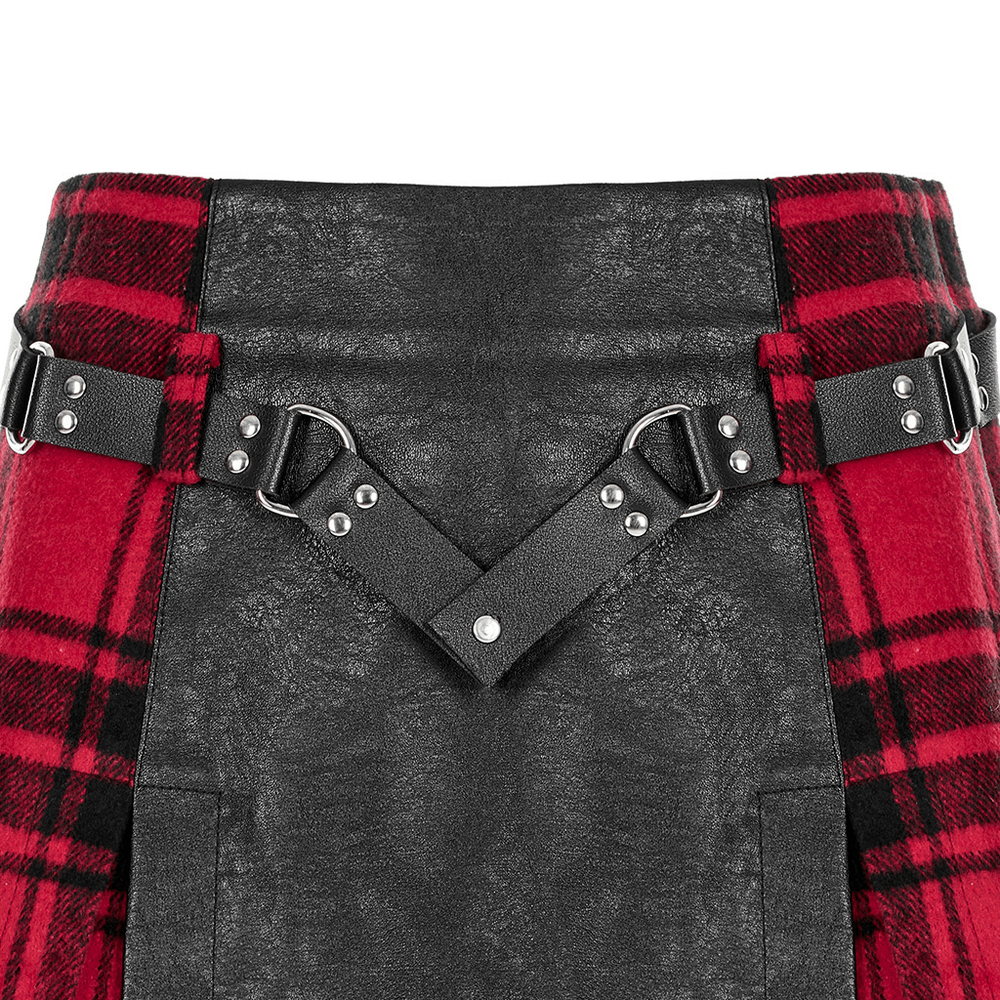 Close-up of punk faux leather and plaid mini skirt featuring rivet belt detailing.