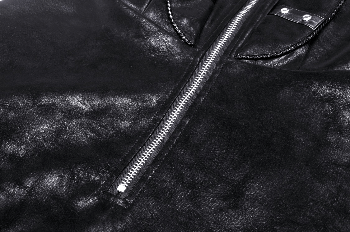 Close-up of black faux leather dress featuring a bold zipper detail and shiny texture, perfect for a punk-inspired look.