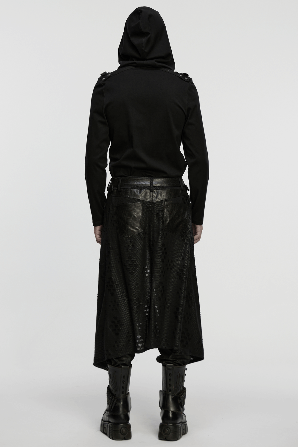 Back view of a model wearing a Punk Faux Leather Tattered Knitted Kilt for Men, paired with a hoodie and combat boots.