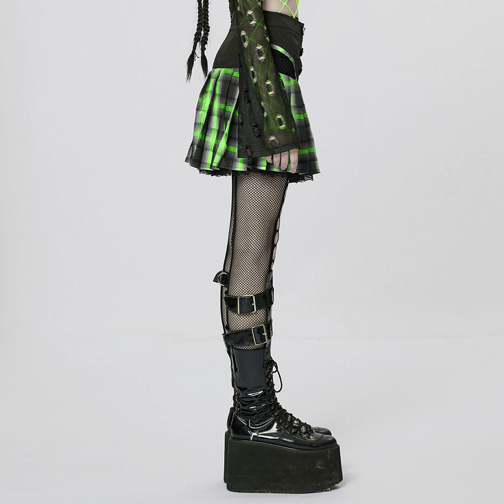Punk female in a black and green plaid pleated skirt, showcasing hollow sides and stylish platform boots.