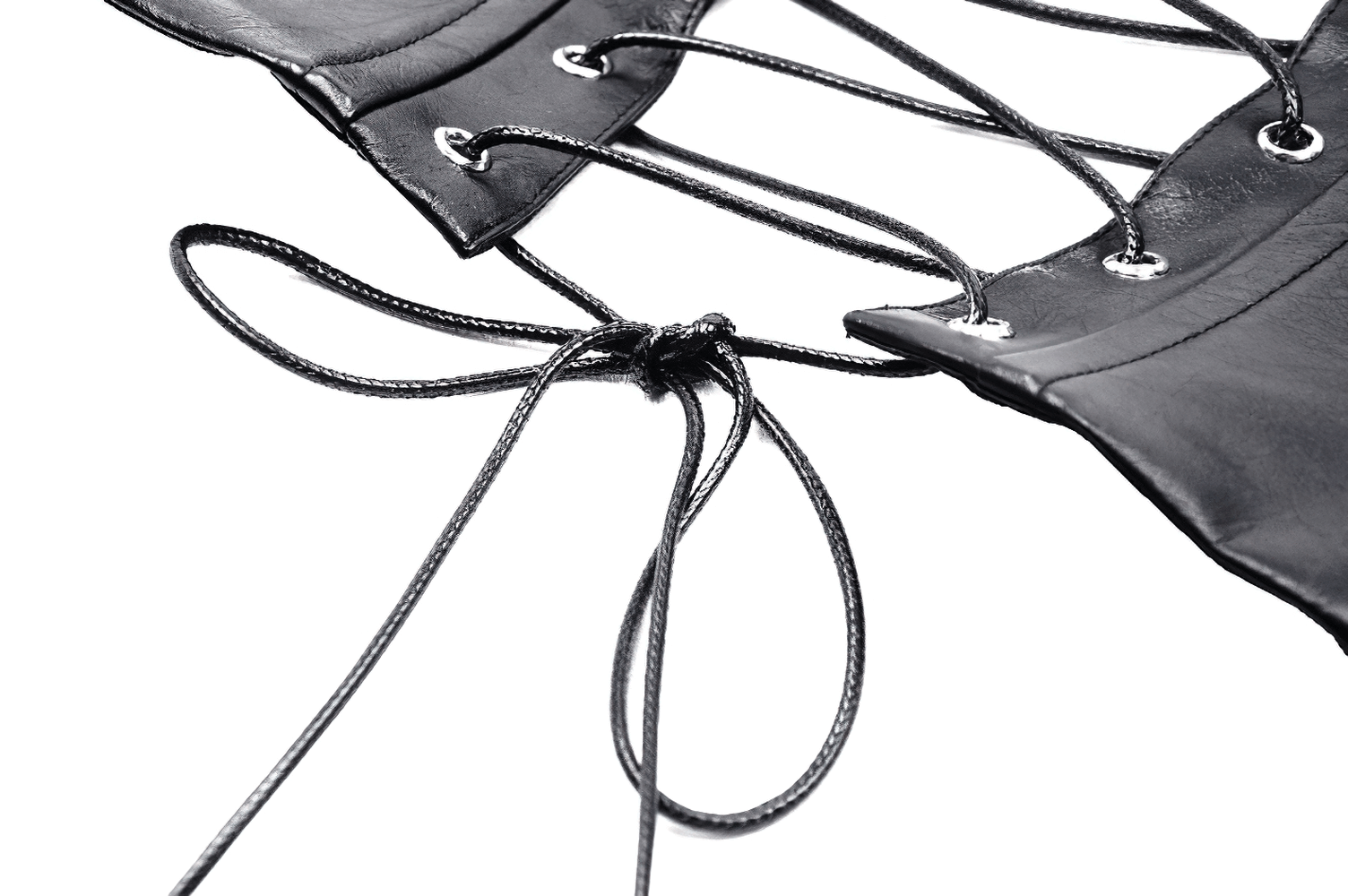 Close-up of a black PU leather corset belt with intricate lacing and silver eyelets for a punk-inspired look.