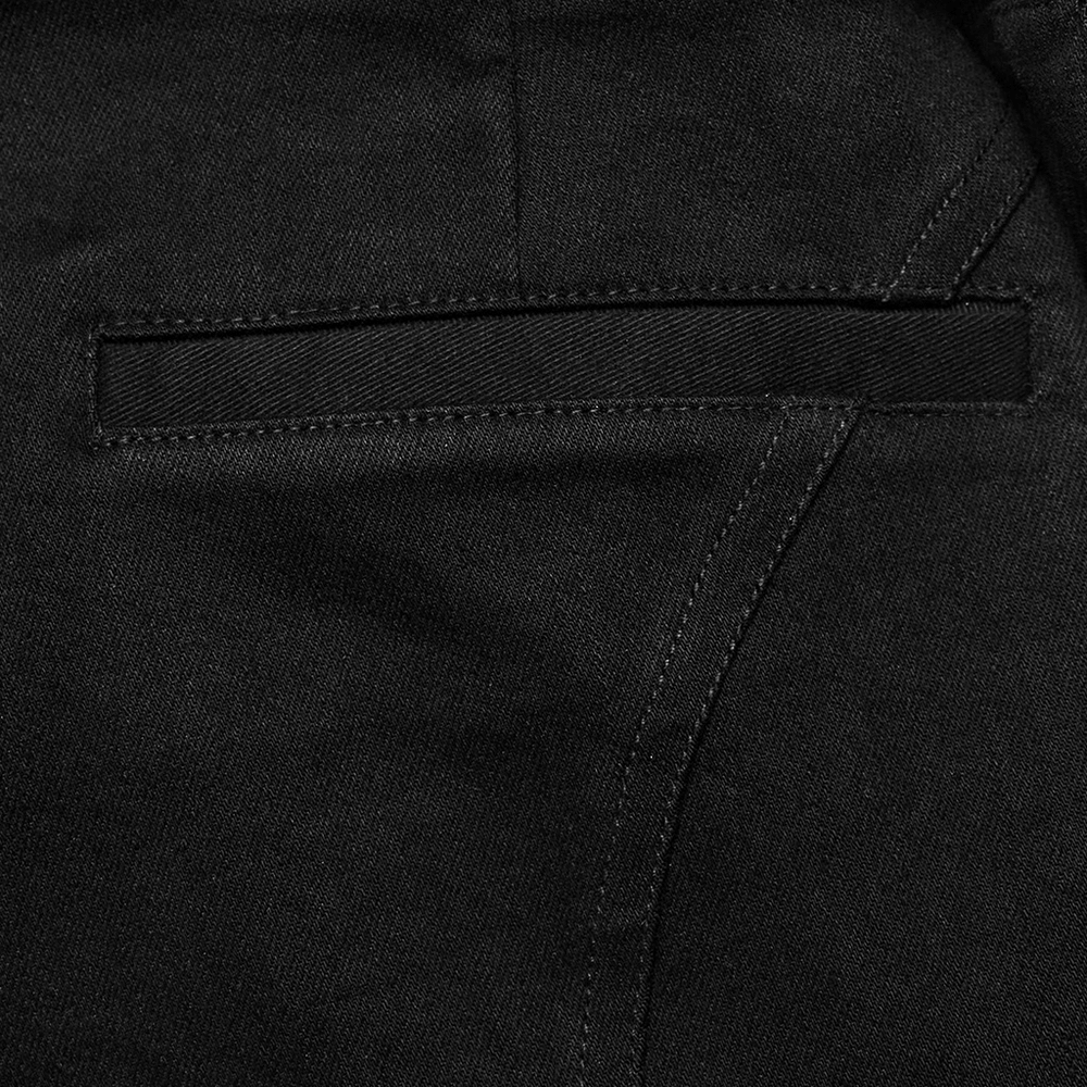 Close-up of black denim shorts featuring a sleek detachable cargo pocket for punk rock style.
