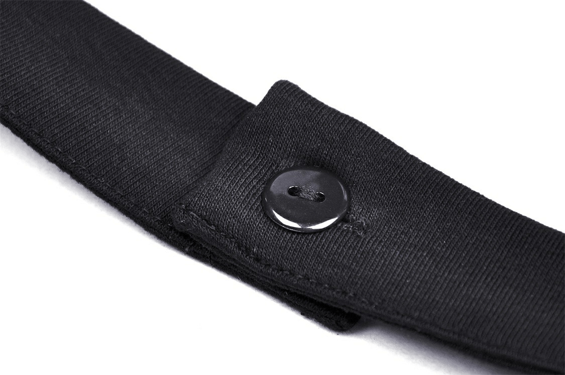 Close-up of a black fabric strap with button detailing, perfect for accessories or clothing outfits.