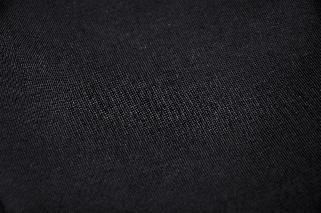 Close-up of soft black fabric, perfect for edgy punk crop tops with mesh detailing.