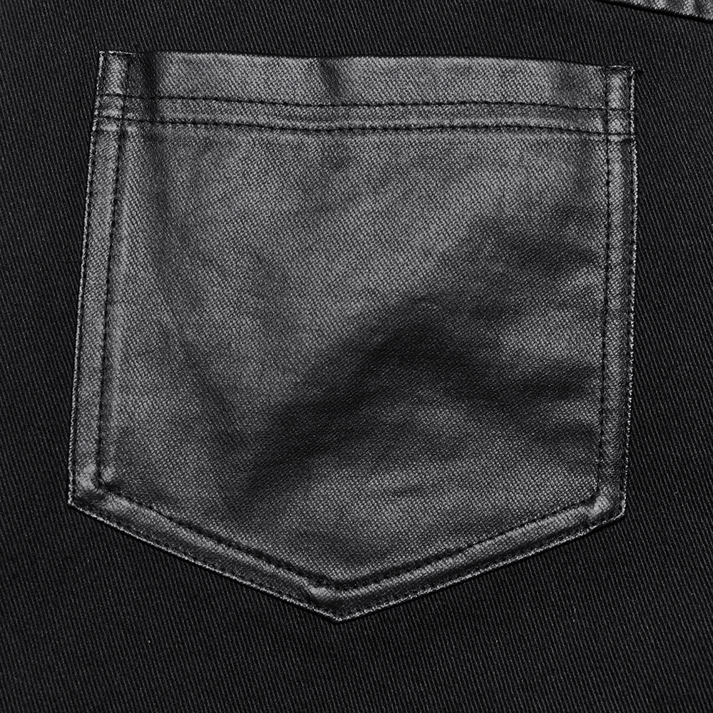 Close-up of a black pocket from women's punk flare trousers with leather panels and rivets.