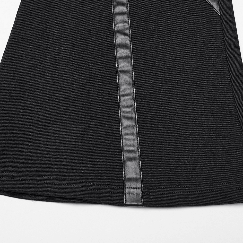 Close-up of black punk flare trousers featuring leather panels and sleek stitching details.