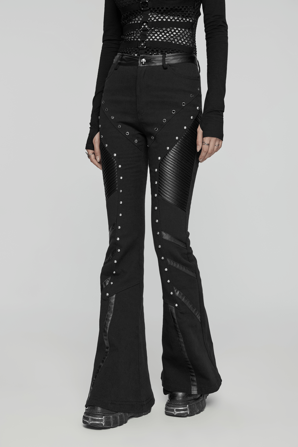 Women's black punk flare trousers with rivets and leather panels for an edgy look.