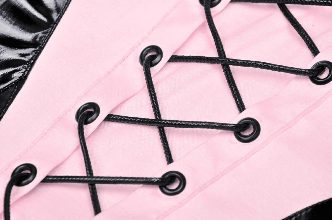 Close-up of pink lace-up detail with black eyelets on punk glossy vinyl mini dress.