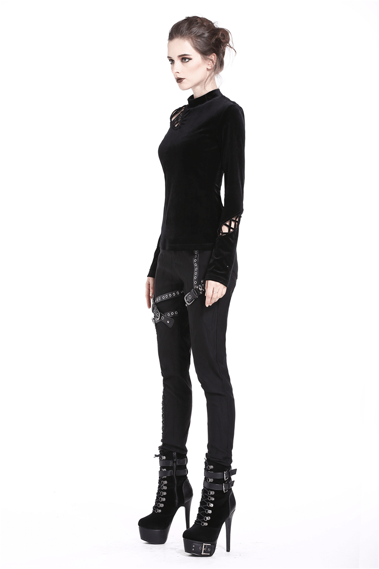 Punk goth model wearing a lace-up velvet turtleneck and black skinny pants with high heels, showcasing a bold darkwear style.