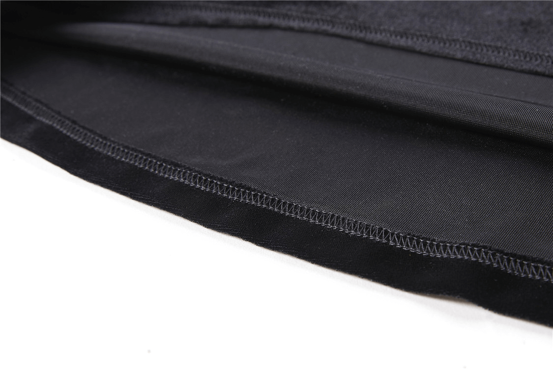 Close-up of soft black velvet fabric showcasing lace-up details of a punk goth turtleneck top.