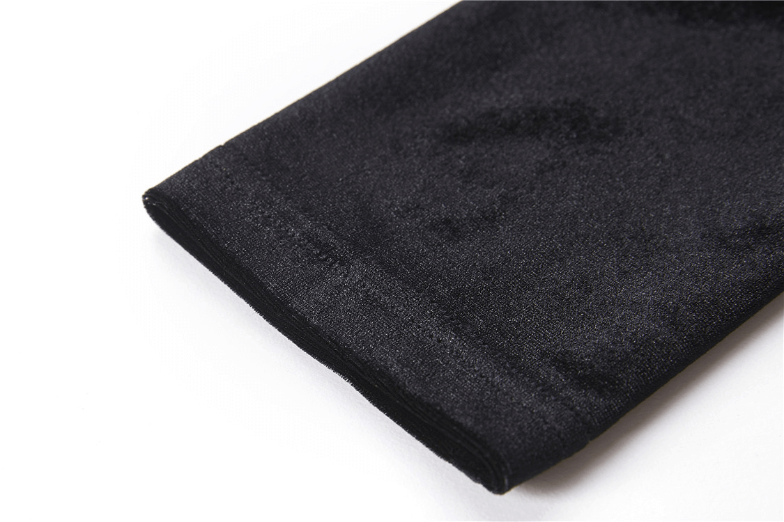 Close-up of the luxurious black velvet fabric of a punk goth lace-up turtleneck top.