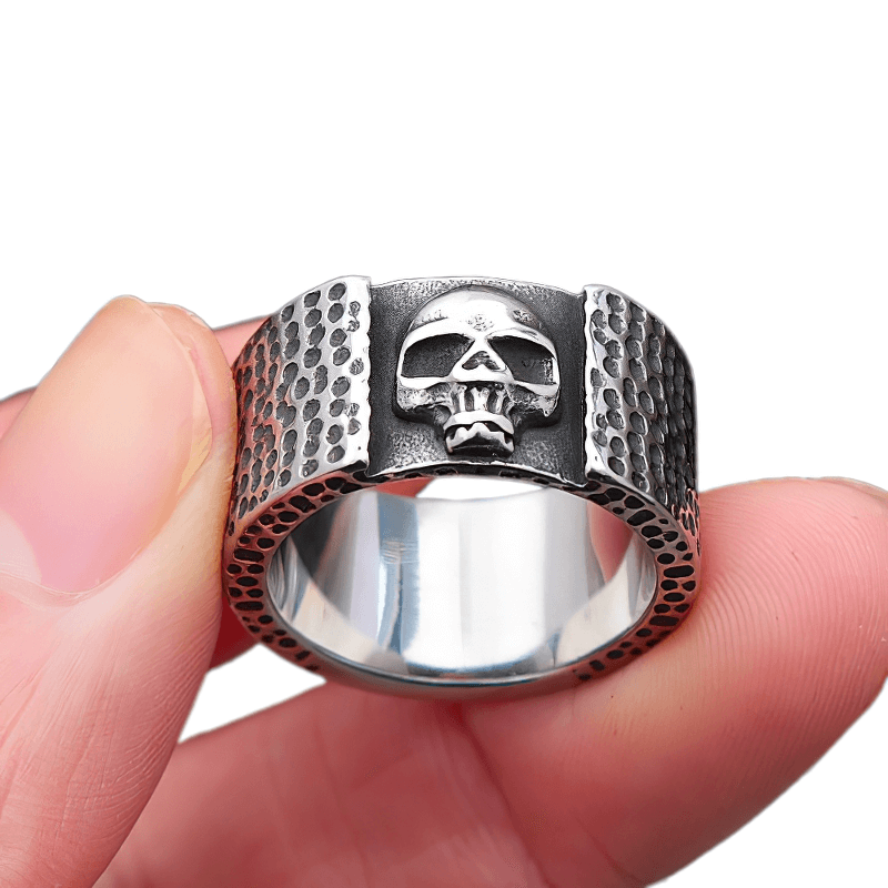 Unisex stainless steel skull ring held in hand, showcasing punk biker style and edgy allure.