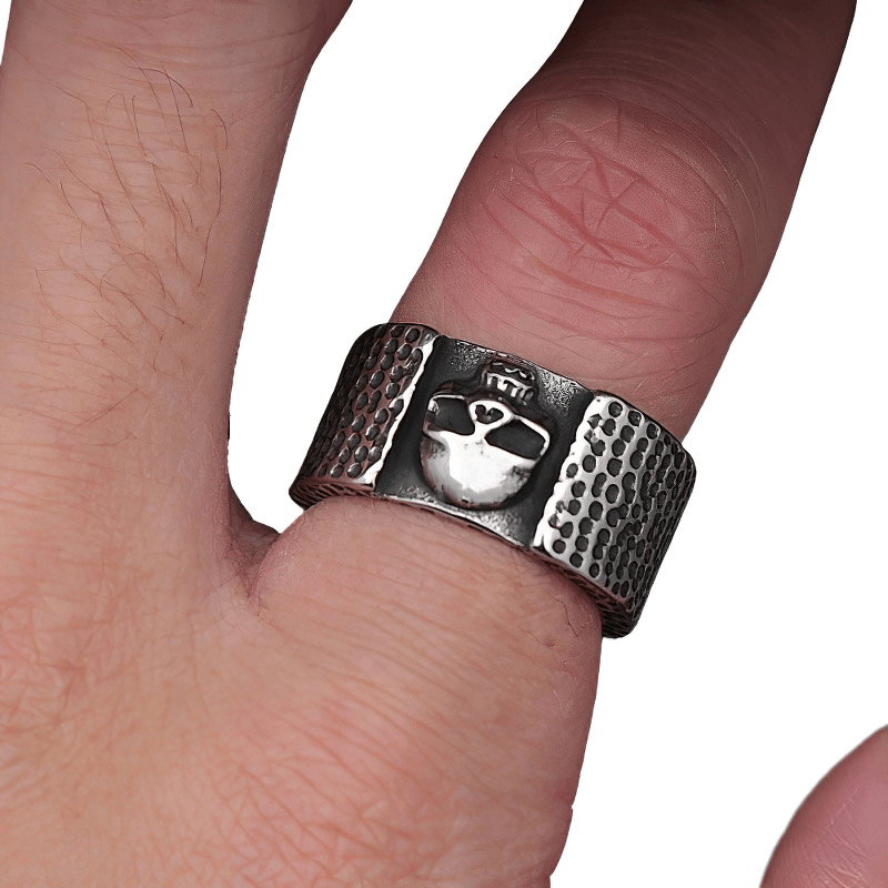 Unisex punk gothic stainless steel skull ring on a finger showcasing edgy motorcycle biker style.