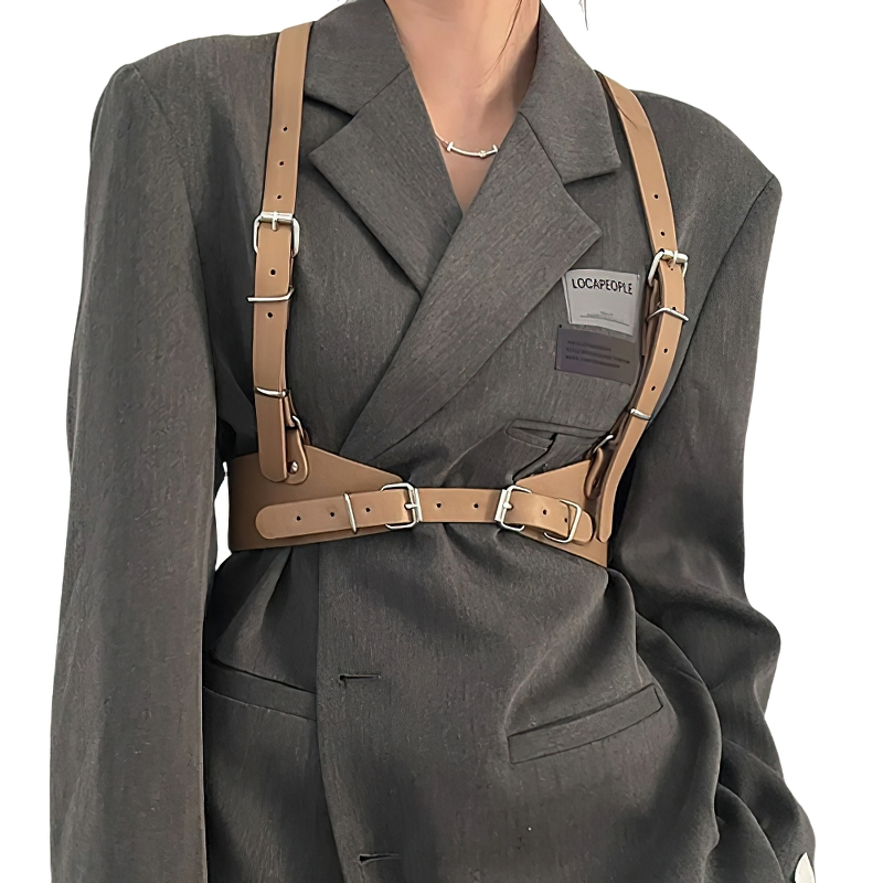 Punk gothic style adjustable strap harness belt worn by model in stylish gray blazer outfit.