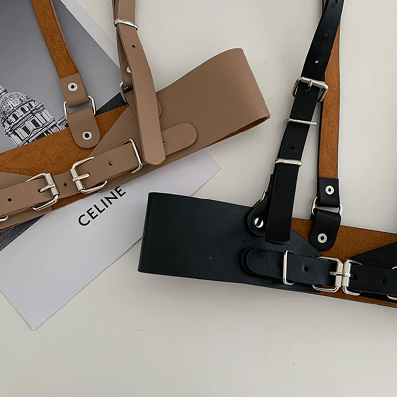 Punk gothic adjustable strap belts in black and tan placed over stylish Celine print, perfect for women’s fashion.