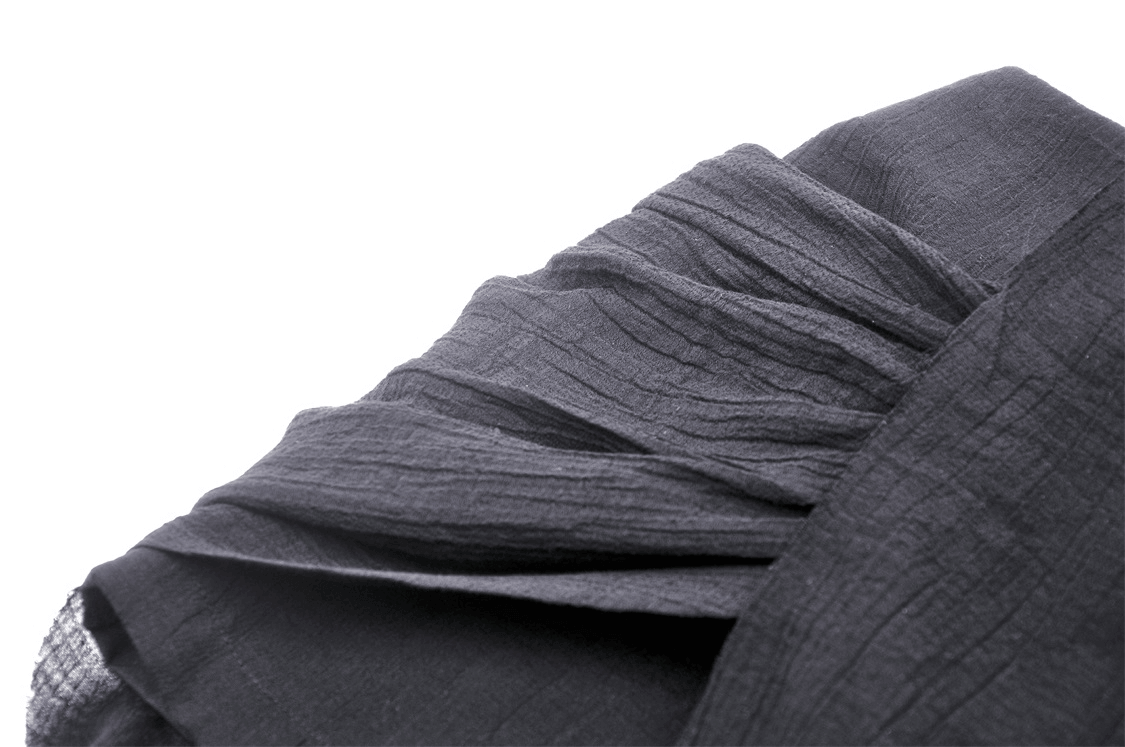 Close-up of black fabric with pleated texture, ideal for a punk high-low skirt with lace detail.
