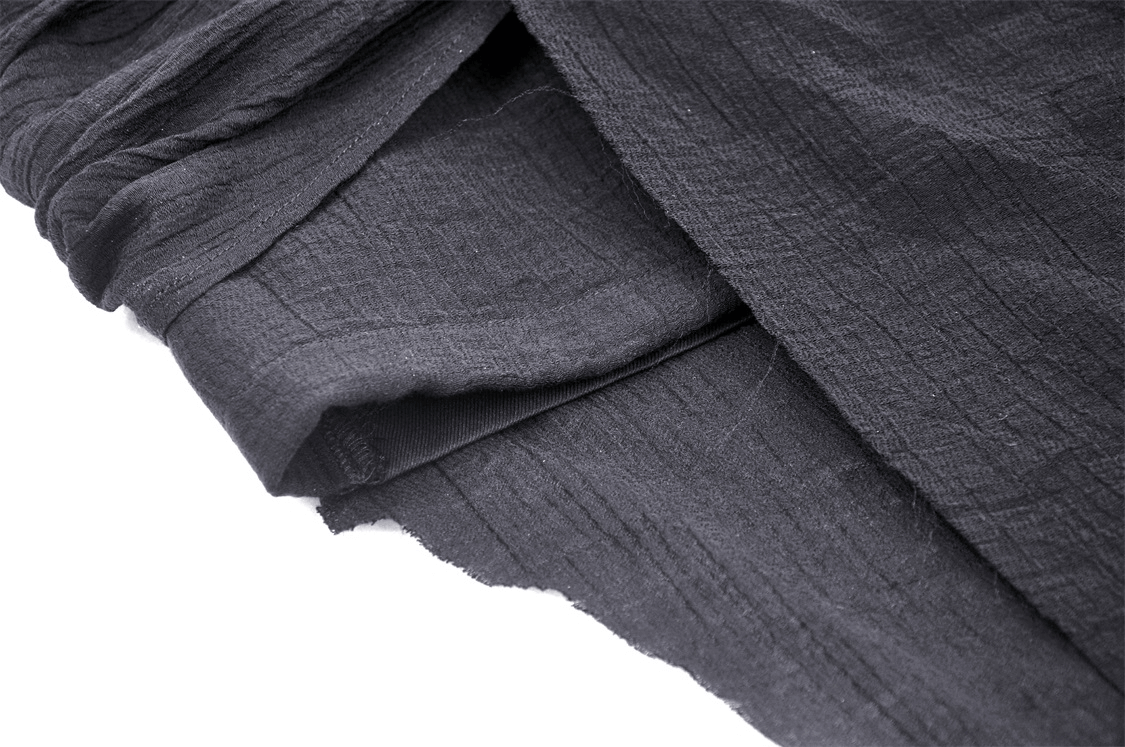 Close-up of soft black fabric showcasing the texture of a gothic asymmetrical skirt.