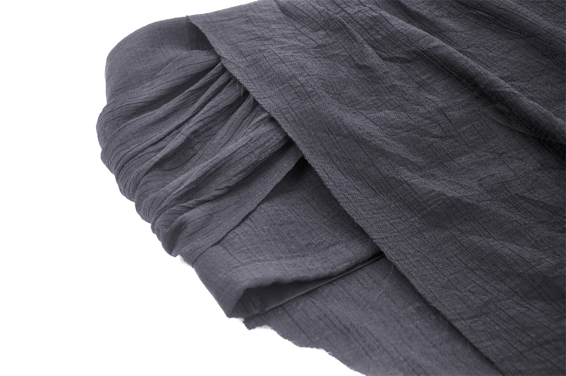 Close-up of the soft, flowy fabric of a black gothic asymmetrical skirt, showcasing its elegant texture and design.