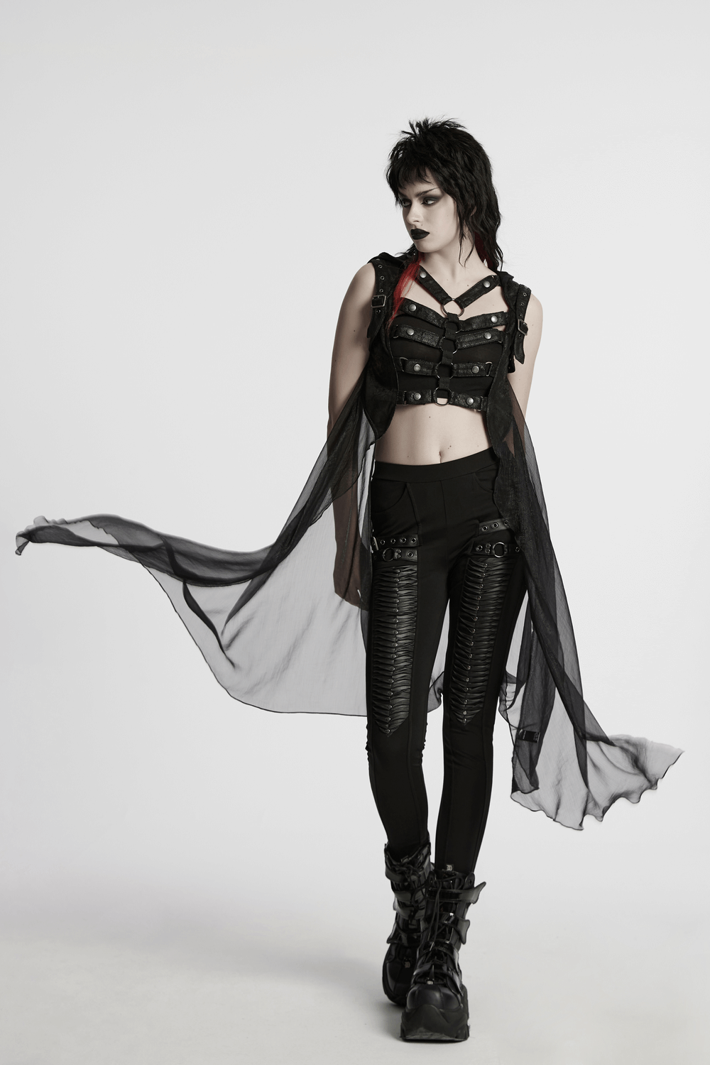 Model in punk hooded skeleton cape with metal rings, showcasing edgy fashion and bold style.