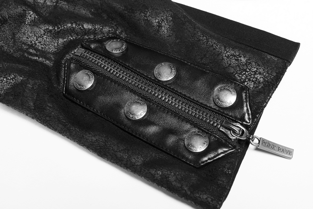 Close-up of punk-inspired coat sleeve with zipper and metallic buttons detail, showcasing edgy black rubber texture.