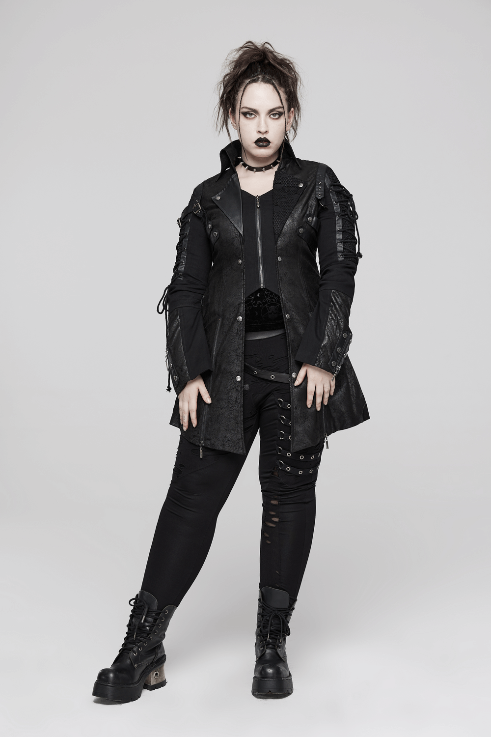 Punk-inspired black rubberized coat with laces, edgy style for bold fashion lovers.