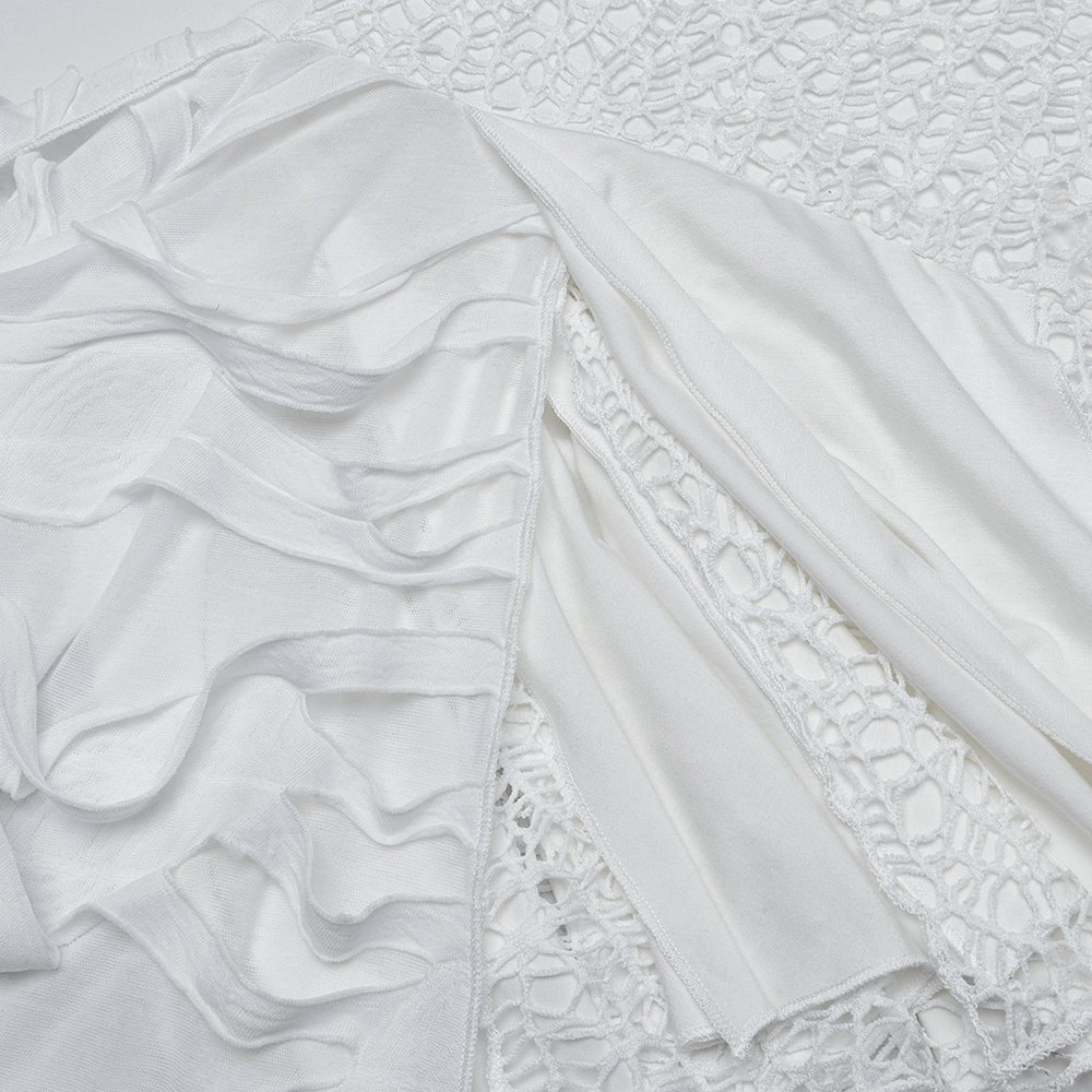 Close-up of elegant white fabric showing ruffles and mesh detailing for a punk-inspired sleeveless dress.