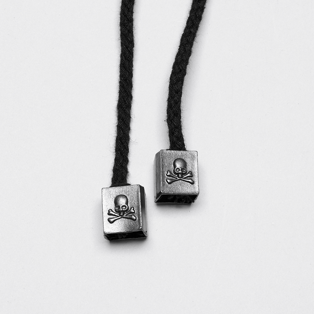 Black cords with metal skull and crossbones accents for gothic fashion accessories.