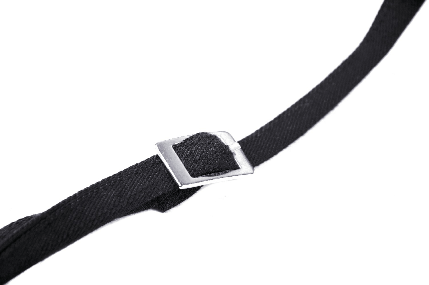 Close-up of a black strap with a metal buckle for punk corset fashion.