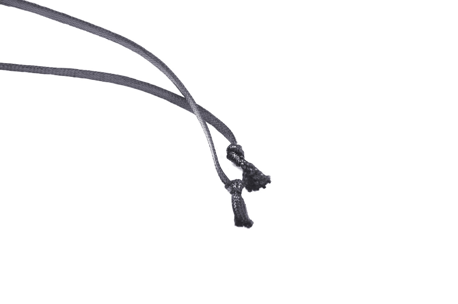 Close-up of black lace-up ties with decorative tassels, perfect for punk fashion garments.