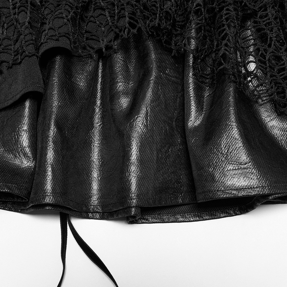 Close-up of punk lace-up skirt showcasing faux leather and intricate mesh detailing for a bold fashion statement.