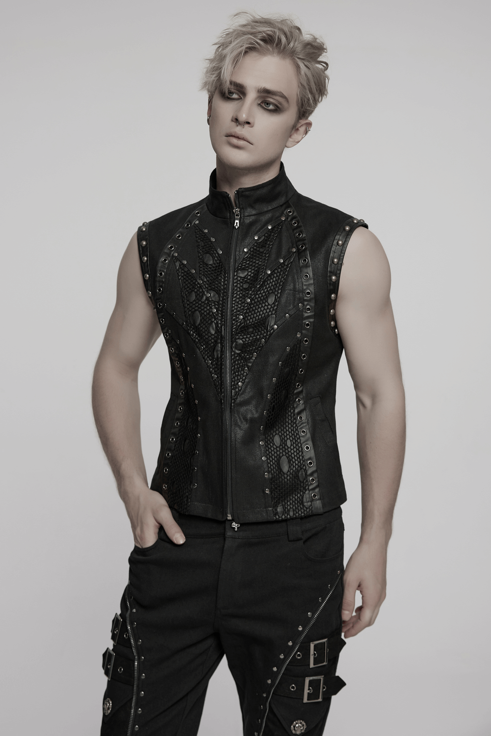 Stylish punk leather and twill vest with rivets, showcasing bold patchwork design and edgy aesthetic.