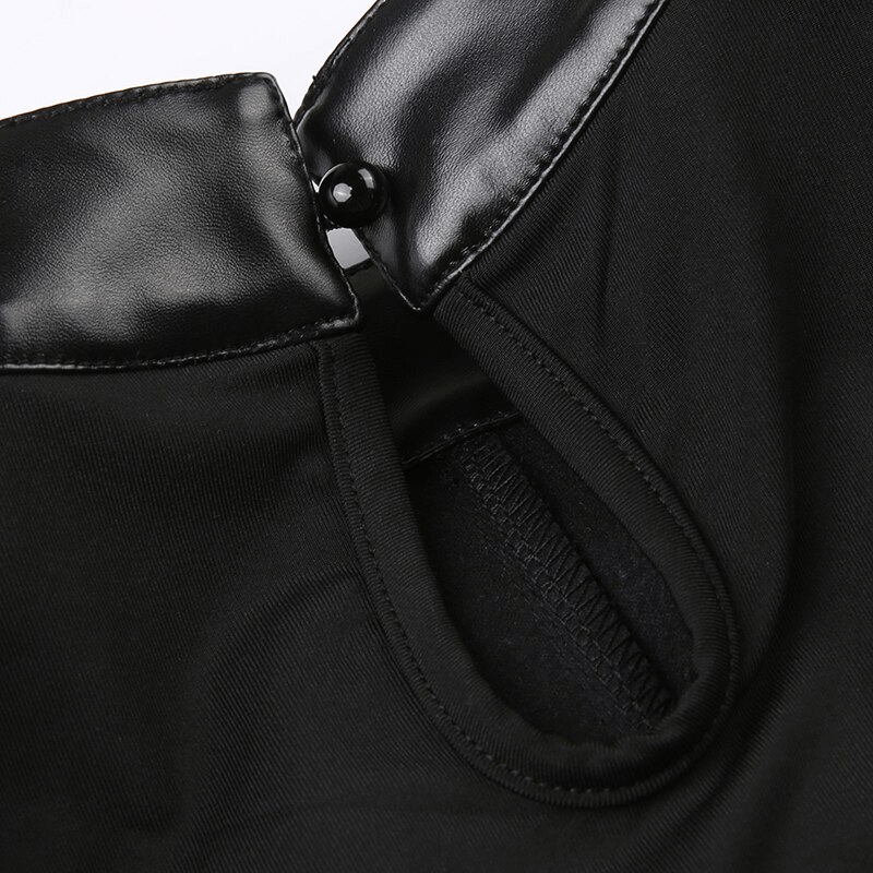 Close-up of the leather buckle and stitching detail on a punk women's sleeveless crop top.