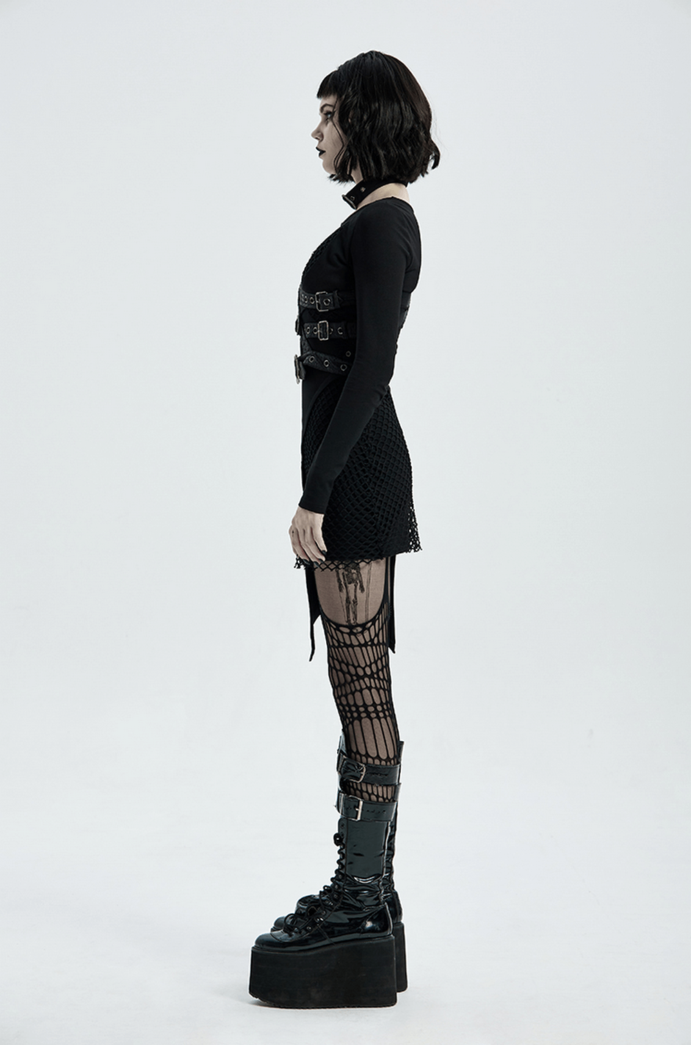 Model wearing Punk Leather Shoulder Body Harness with gothic outfit and platform boots, showcasing edgy metal accents.