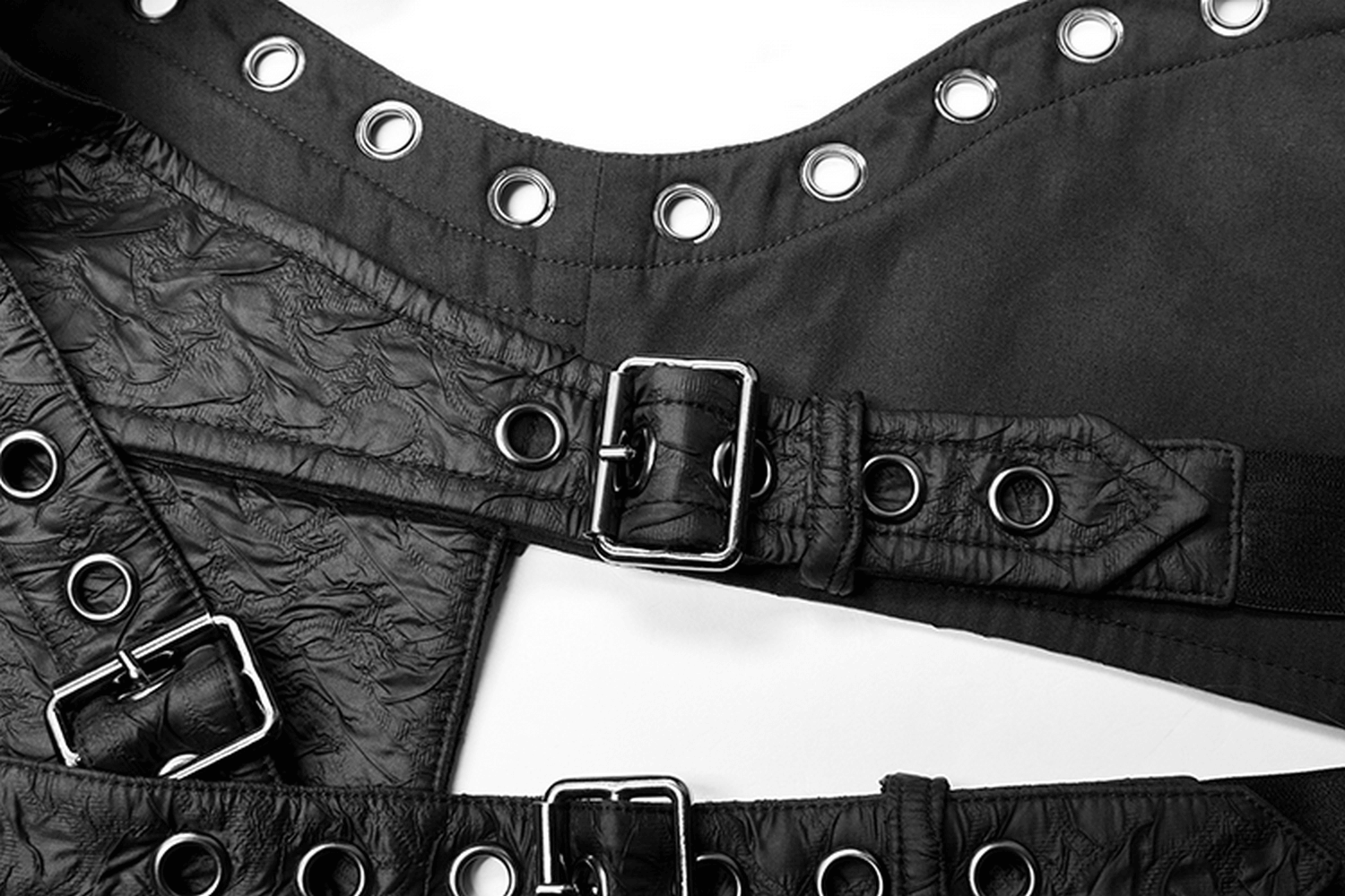 Punk leather shoulder body harness with metal accents and python buckle, featuring a textured fabric and decorative metal eyelets.