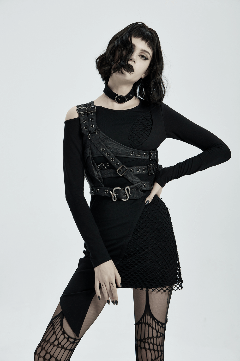Gothic model wearing punk leather shoulder body harness with metal accents and decorative front pocket.