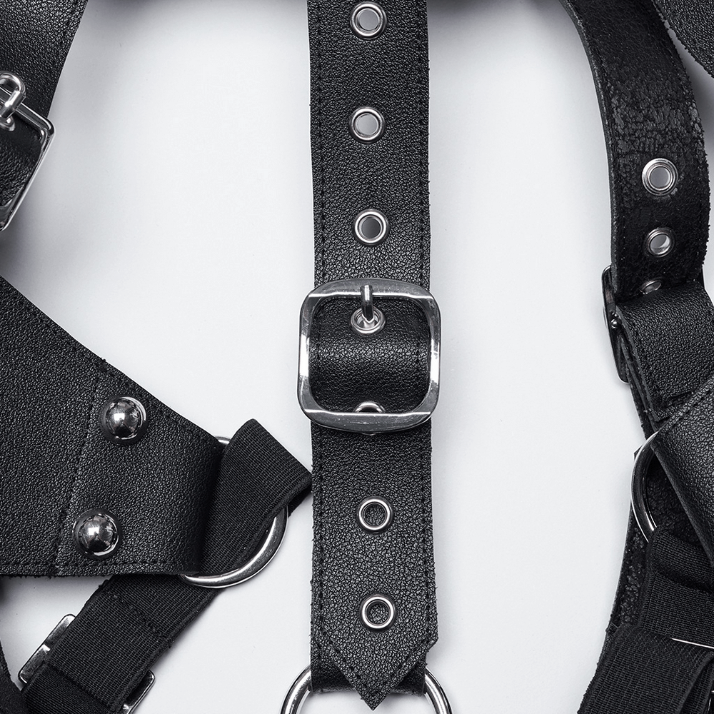 Close-up of punk leather harness featuring metal buckles, studs, and adjustable straps for an edgy look.