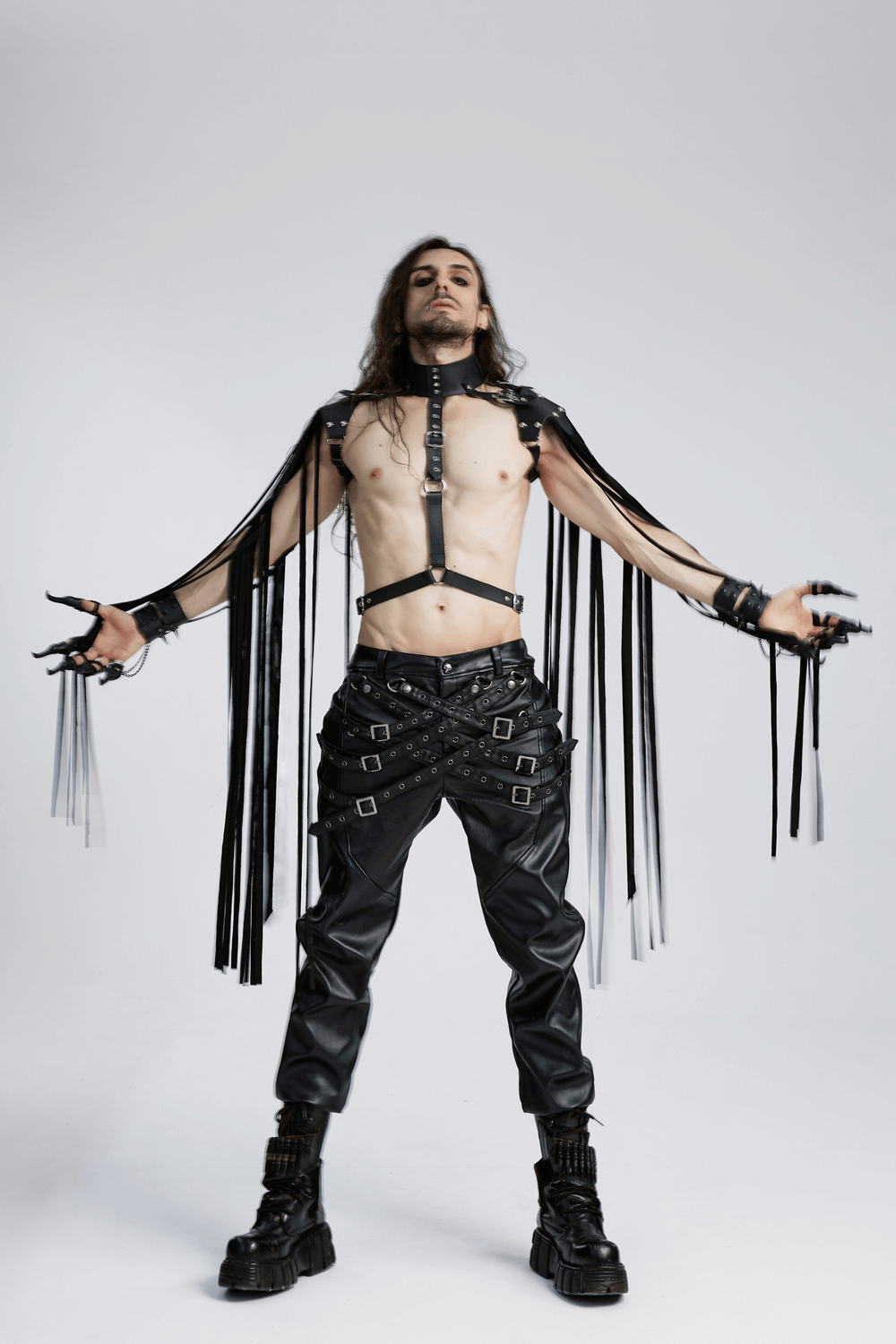 Edgy man wearing punk leather tassel shoulder armor, showcasing bold style and rebellious fashion.