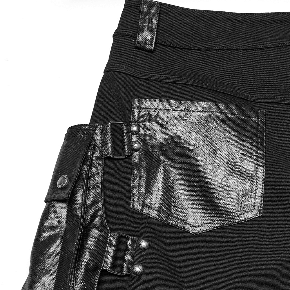 Punk style black shorts with leather trim and oversized pockets detail close-up.
