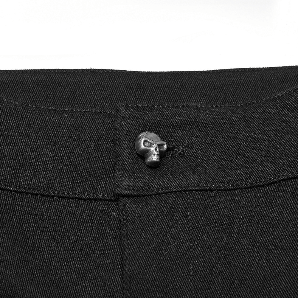 Close-up of punk black shorts featuring a stylish skull button detail for edgy fashion appeal.