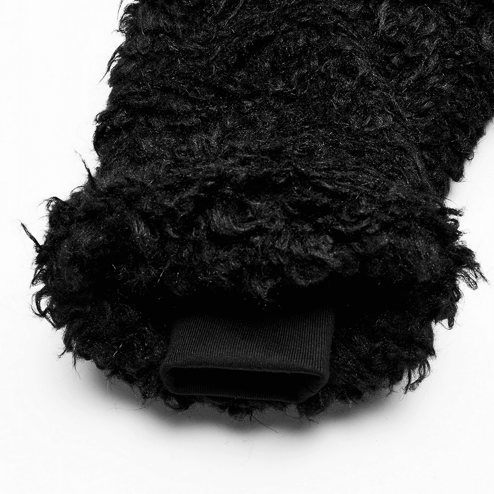 Close-up of the black faux fur sleeve of a punk-style jacket, showcasing soft, textured fabric.