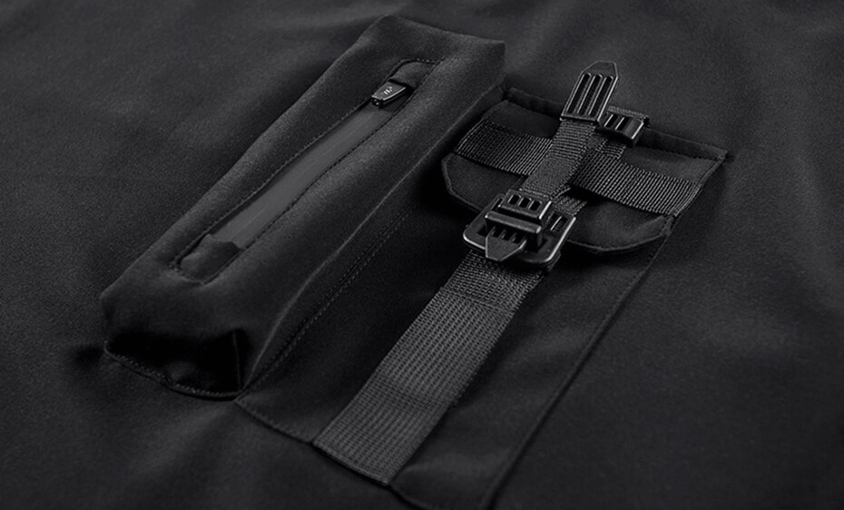 Close-up of a black punk T-shirt showing a zippered pocket and strap details for a stylish streetwear look.