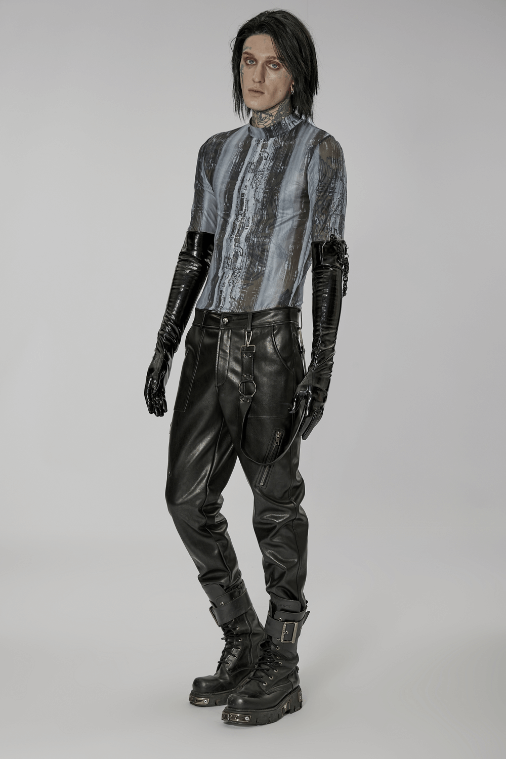 Punk male model showcasing edgy patent leather gloves and stylish attire for a rebellious fashion statement.
