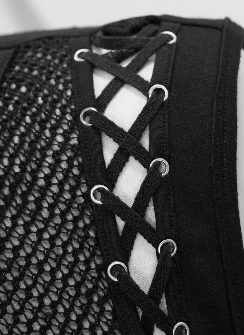 Close-up of black tank top with drawstring and mesh inserts, showcasing punk style and stylish lacing details.